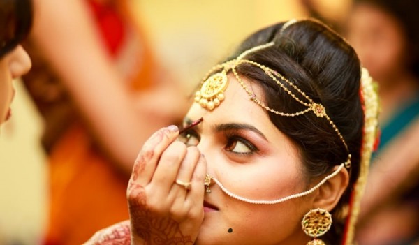 telegu bride having her bindi applied