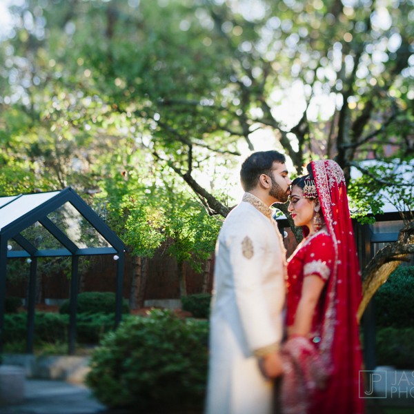 groom kissing his pakistani bride on the forehead
