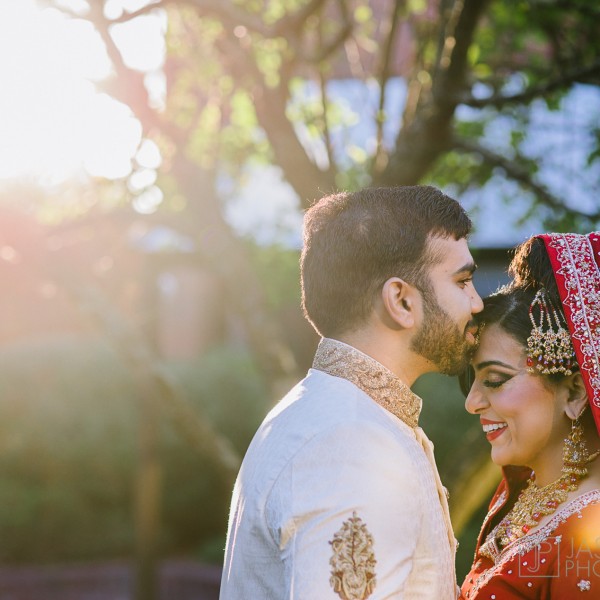 groom kissing his pakistani bride on the forehead