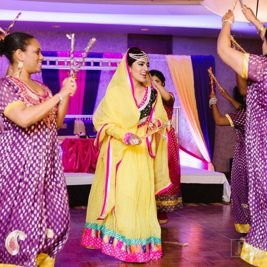 Pakistani bride and bridesmaid dancing at wedding