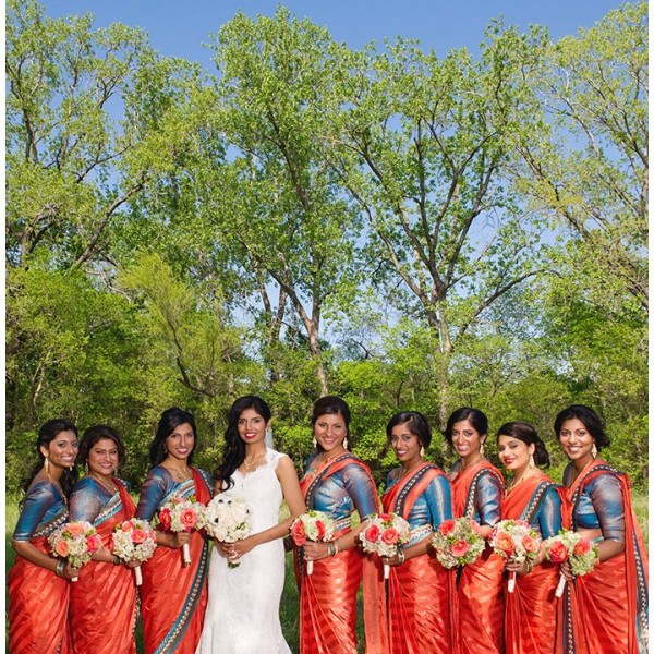 Indian bridesmaids in orange and blue sarees