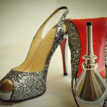 silver slingback louboutin wedding shoes with wedding rings on the heel