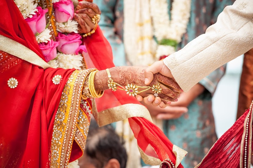 Indian bride and groom holding hands